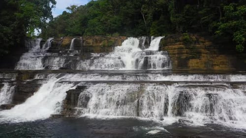 Tiered Waterfall Cascading Through Lush Green Jungle