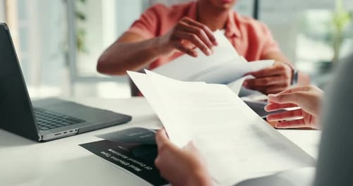 Colleagues Reviewing Documents in Bright Office
