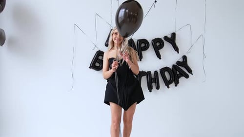 Blonde Woman Poses with Birthday Balloons and Celebrates