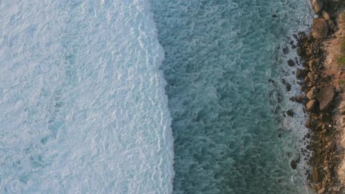 Waves Crashing on Rocky Coastline, Aerial View