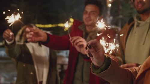 Friends Celebrating With Sparklers at Night