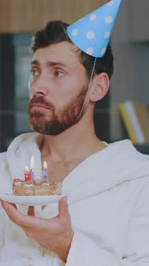 Solitary Figure with Cake in Quiet Room An Individual Marks Birthday Solo in Peaceful Apartment