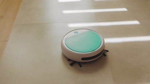 New York USA March 19 2020 Smart Home Concept White Robotic Cleaner Machine Driving on the Floor