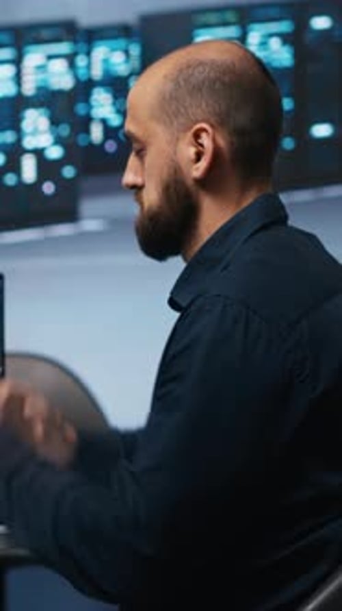 Man Reading Code in Dark Office