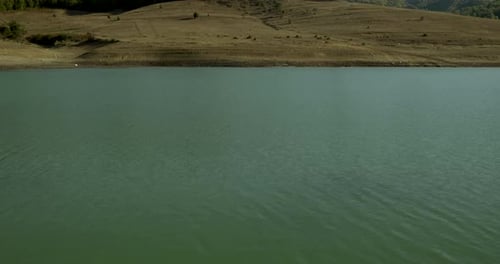 Lake view, reflections in the lake. The hills behind the lake.