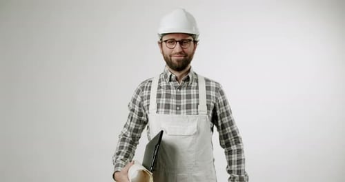 Construction Worker Approves with Nod Blueprints and Clipboard in Hand