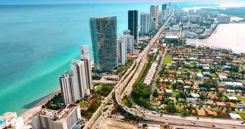 Drone descending above the multi-lane highway with multiple transport moving on