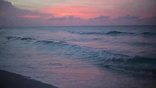 Beautiful Sunset by the Sea. Ocean Waves Crashing on the Shore at Sunset.