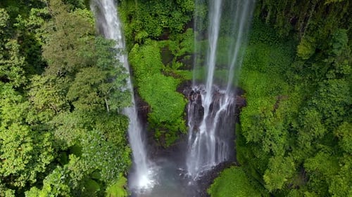 Drone View of Cascading Waterfall Surrounded By Tropical Jungle in Bali Indonesia