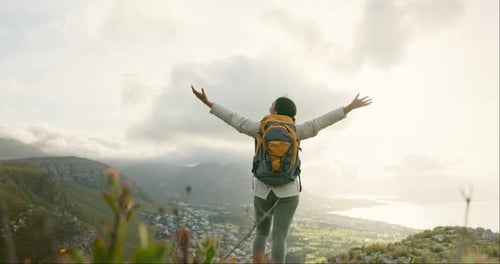 Woman, mountain top and freedom or success for hiking goals, travel or trekking adventure in nature