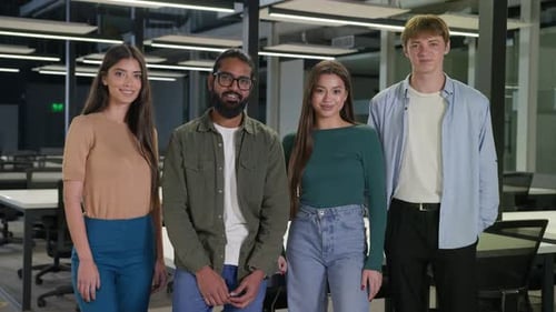 Smiling Young Adults Standing Together in Office