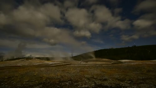 Time lapse of Old Faithful in Yellowstone National Park on a windy day at dusk
