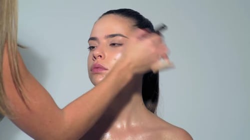 Makeup Artist Applies Makeup with Cosmetic Brush Beauty Visage Makeup Master with Young Beauty Model