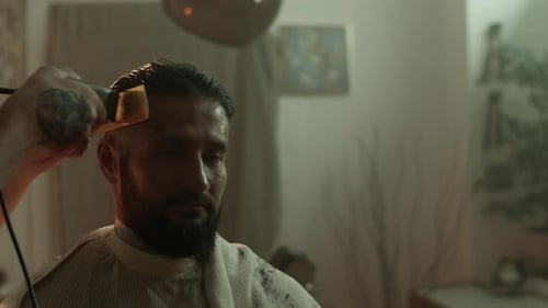 Barber Giving Haircut to Man with Electric Razor