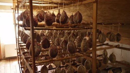 Cured Meats Hanging on Racks Inside Room