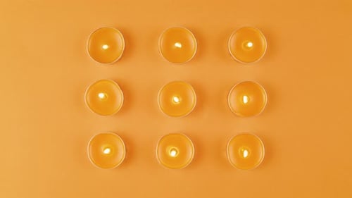 Aroma Candles with Glitter Sprinkles on Orange Background Close Up Top View Summer Bright Texture