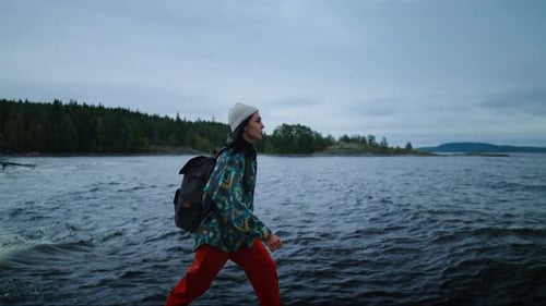Woman Hiker Walks Near Cold Ocean Waters