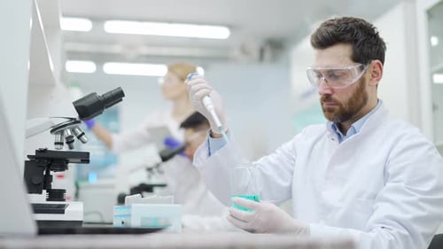 Scientist Using Pipette to Transfer Liquid in Lab