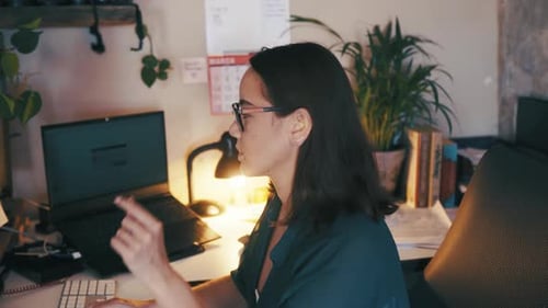 Young Adult Typing at Computer in Office