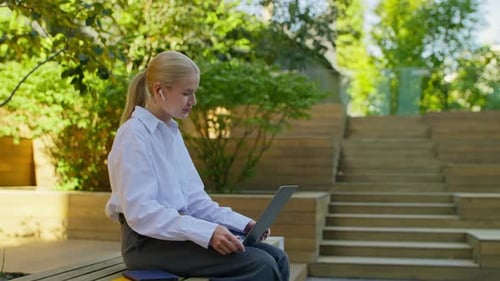 Woman in Business Attire Video Calling on Laptop