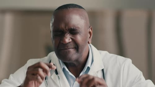 Overloaded Tired Exhausted Sick Man African American Doctor Physician Works at Hospital Touch