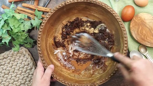 Mixing Cooking Ingredients in Wooden Bowl with Whisk
