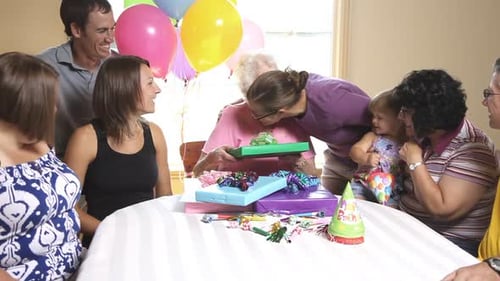 Family gathers to celebrate birthday with presents