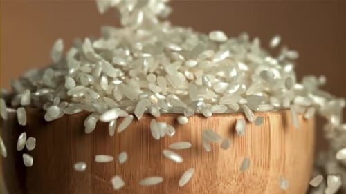 The Rice Falls Into a Wooden Bowl Filmed on a Highspeed Camera at 1000 Fps