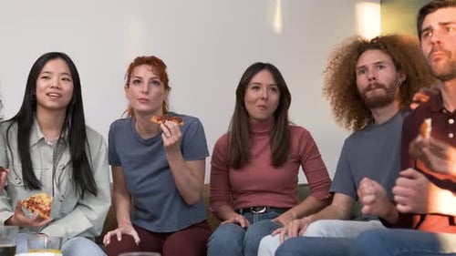 Friends Eating Pizza and Socializing on Couch
