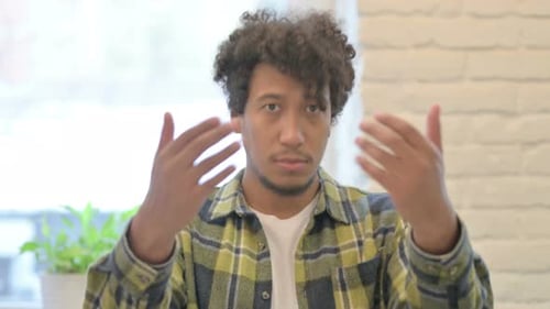 Young Adult Man Gestures Come Here Indoors