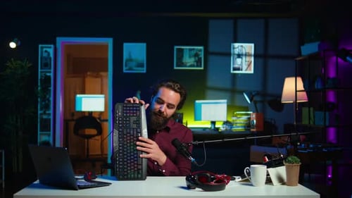 Man in Studio Reviewing Gaming Keyboard Received From Sponsoring Brand