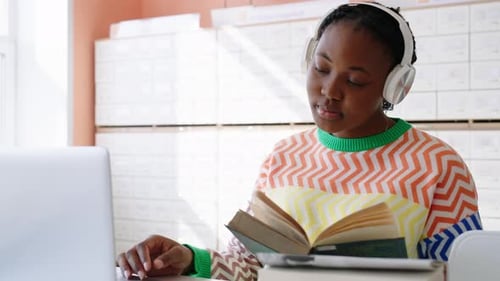 Attractive Young African Woman Studying in Modern Library