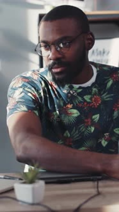 Young Adult Using Tablet at Office Desk