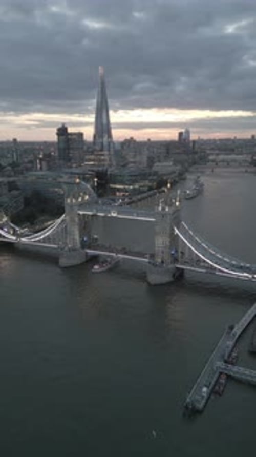 Aerial video of the city of London and the lighthouse bridge in London at night