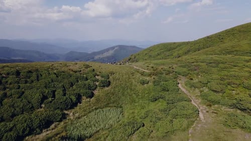 Group of Tourists Walks Along Footpath at Mountain Trekking