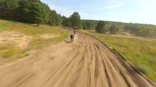 Motorbikes Racing on Dirt Track in Rural Landscape