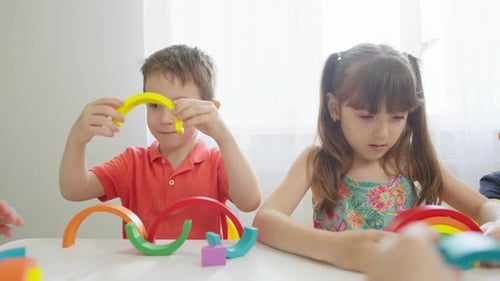 Children Build Together Using Colorful Rainbow Blocks