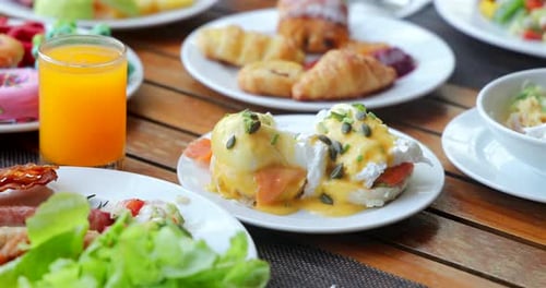 Delicious Breakfast Table with Eggs Benedict and Juice