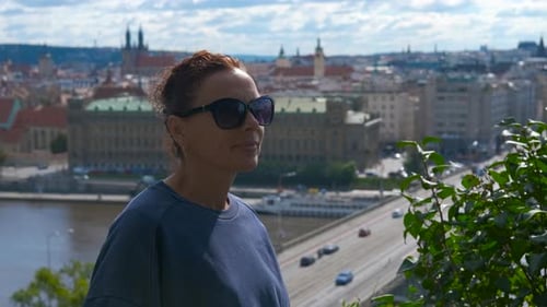Tourist Admiring Prague Cityscape From a Hilltop Vantage Point