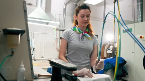 Woman Removing Stain in Commercial Laundry Setting
