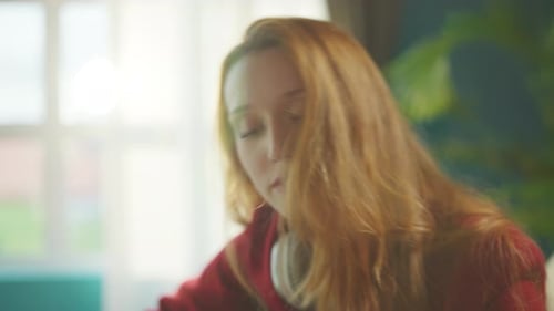 Woman Plays Guitar and Sings at Home