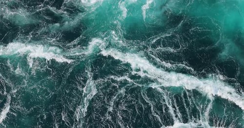Blue waves of water of the river and the sea meet each other during high tide and low tide.