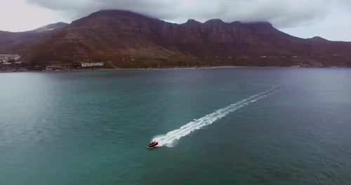Speedboat, drone and ocean or sea with waves for travel, vacation or holiday with mountain