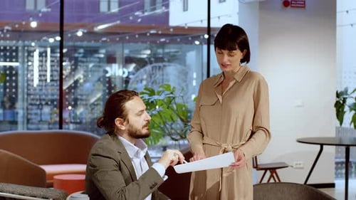 Business Meeting Between Colleagues in Modern Office