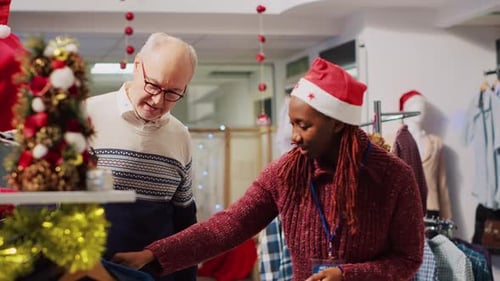 Customer Shopping with Assistant in Festive Clothing Store