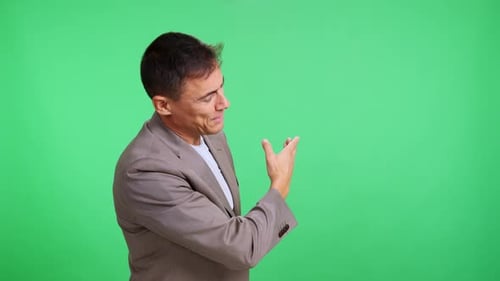 Expressive Man Presenting a Concept on a Green Screen