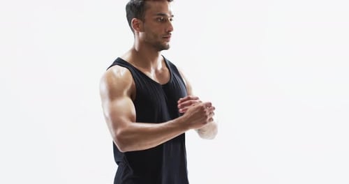 Young biracial athlete man stretches before a workout on a white background, with copy space
