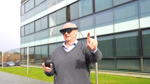 Senior Man Interacting with Augmented Reality Glasses