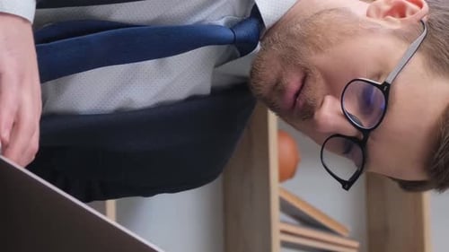 Busy Businessman in Office Working on His Laptop Vertical Video