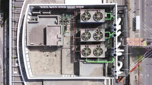 Aerial view of a large office building roof with various ventilation.